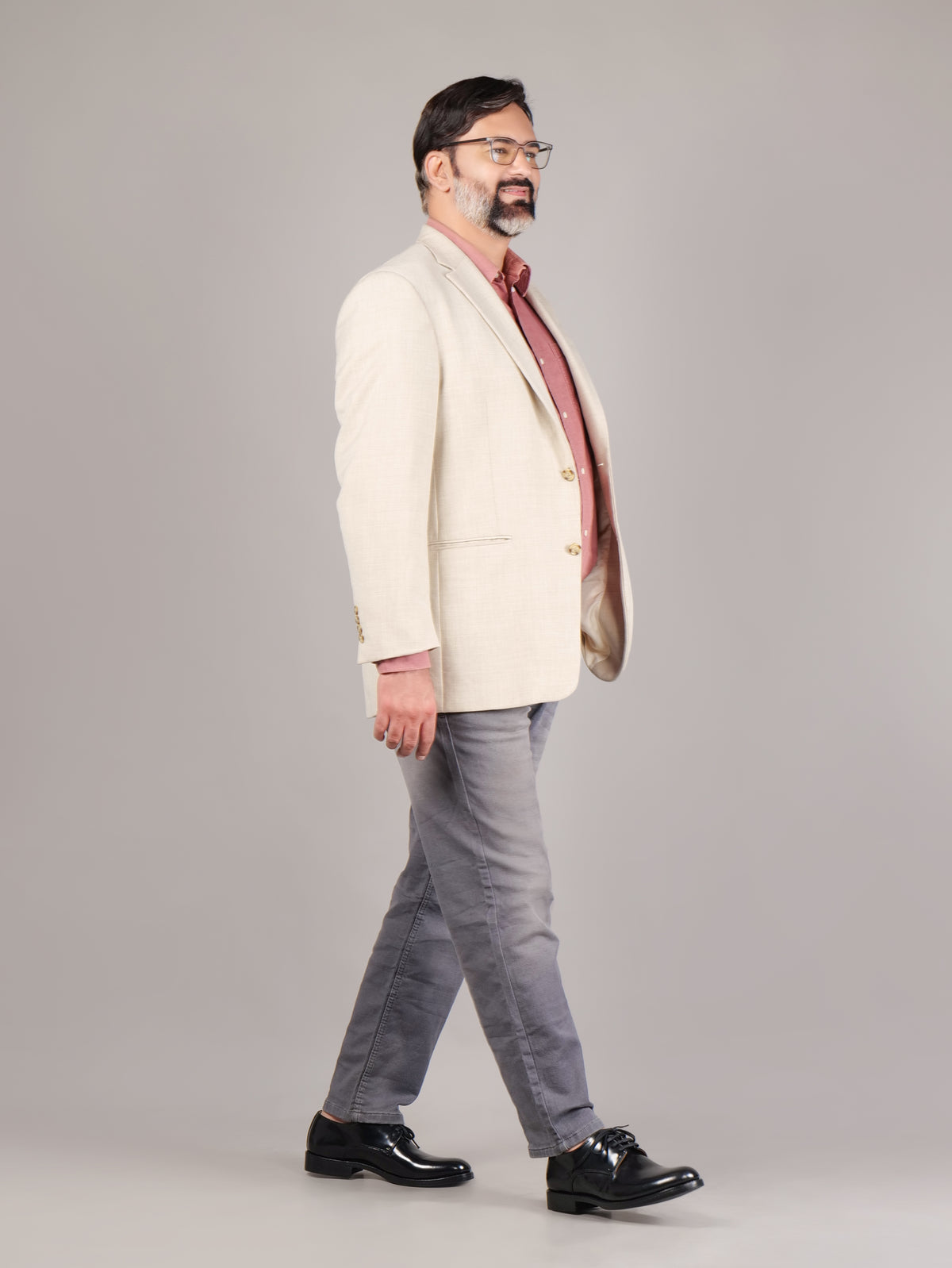 Male model wearing black Blucher Goodyear welted series shoes in a walking pose against a light gray background