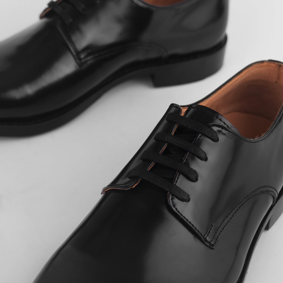 Close-up of black Blucher Goodyear welted shoes highlighting lace detail
