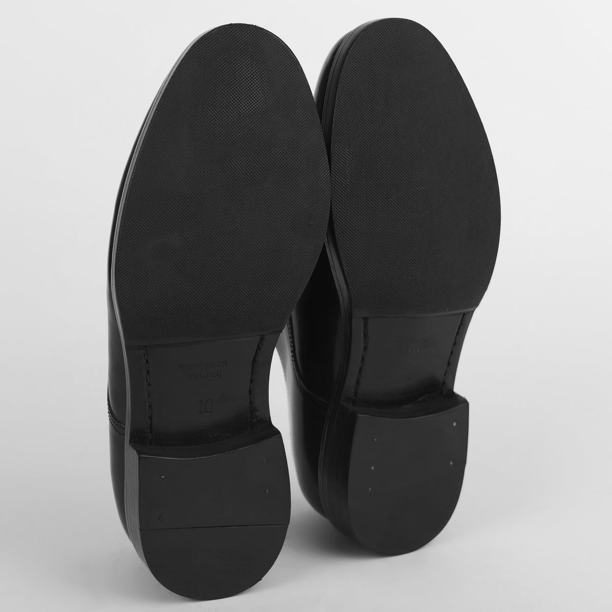 Sole view of black Goodyear welted Blucher shoes showing tread and construction