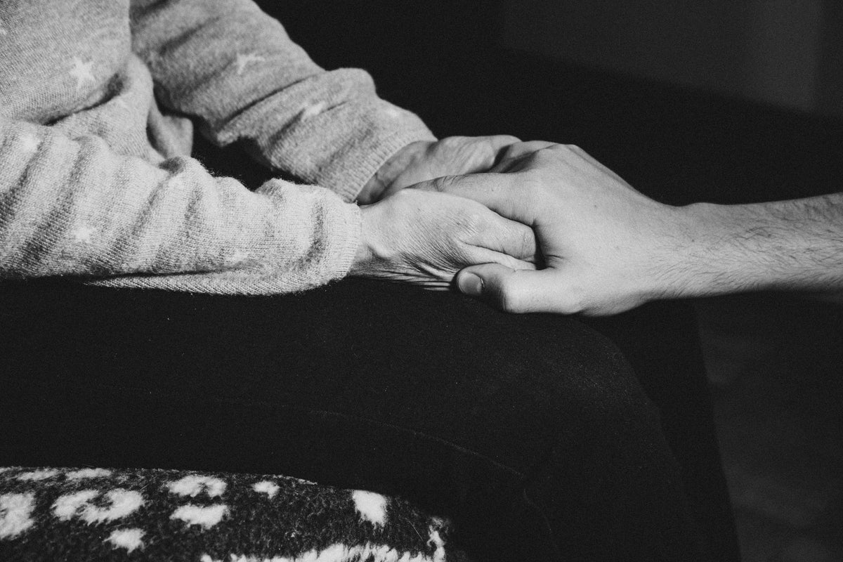 Blucher Shoes customer support – one person holding another’s hand symbolizing trust and care