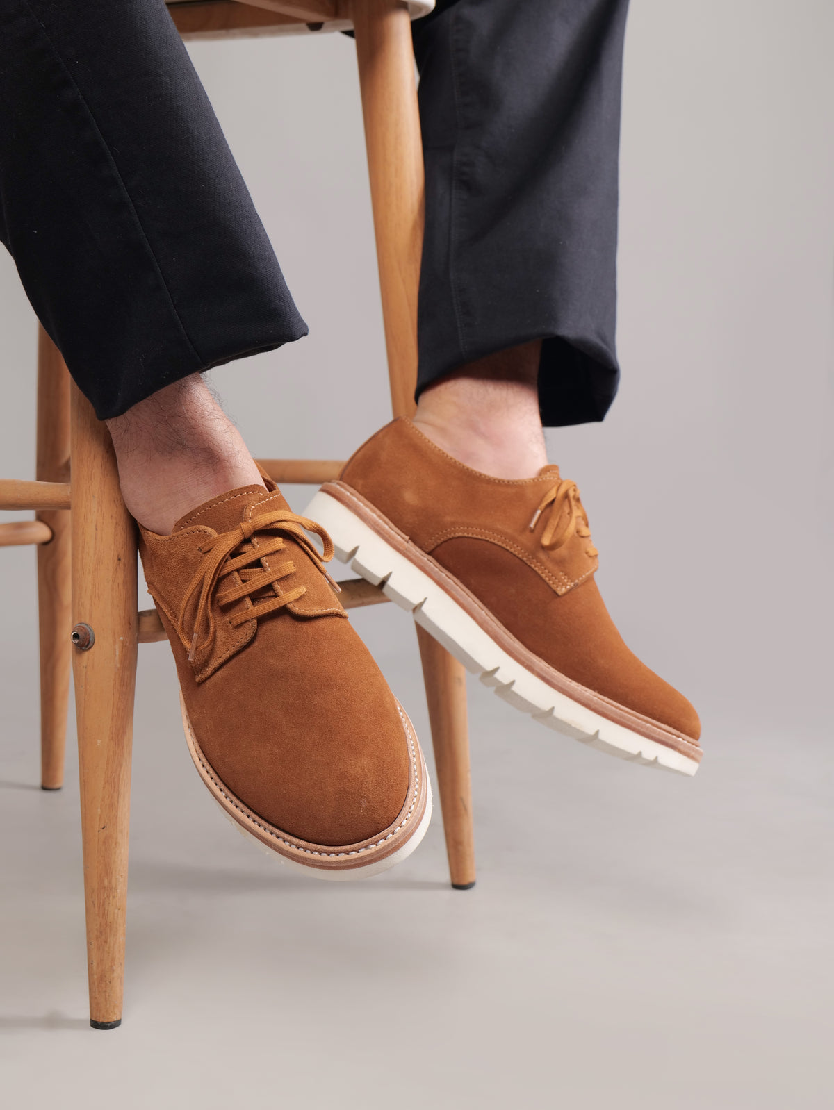 Brown Blucher Suede shoes worn by a seated model, focus on shoe design