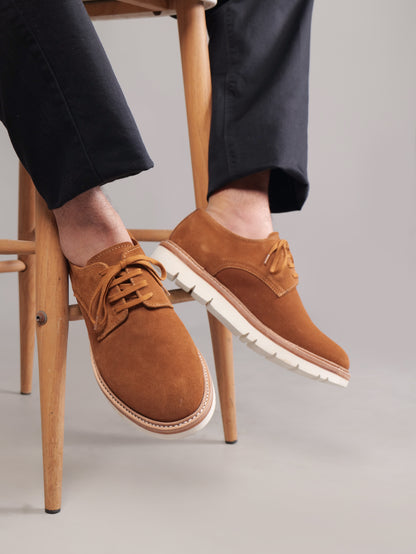 Brown Blucher Suede shoes worn by a seated model, focus on shoe design
