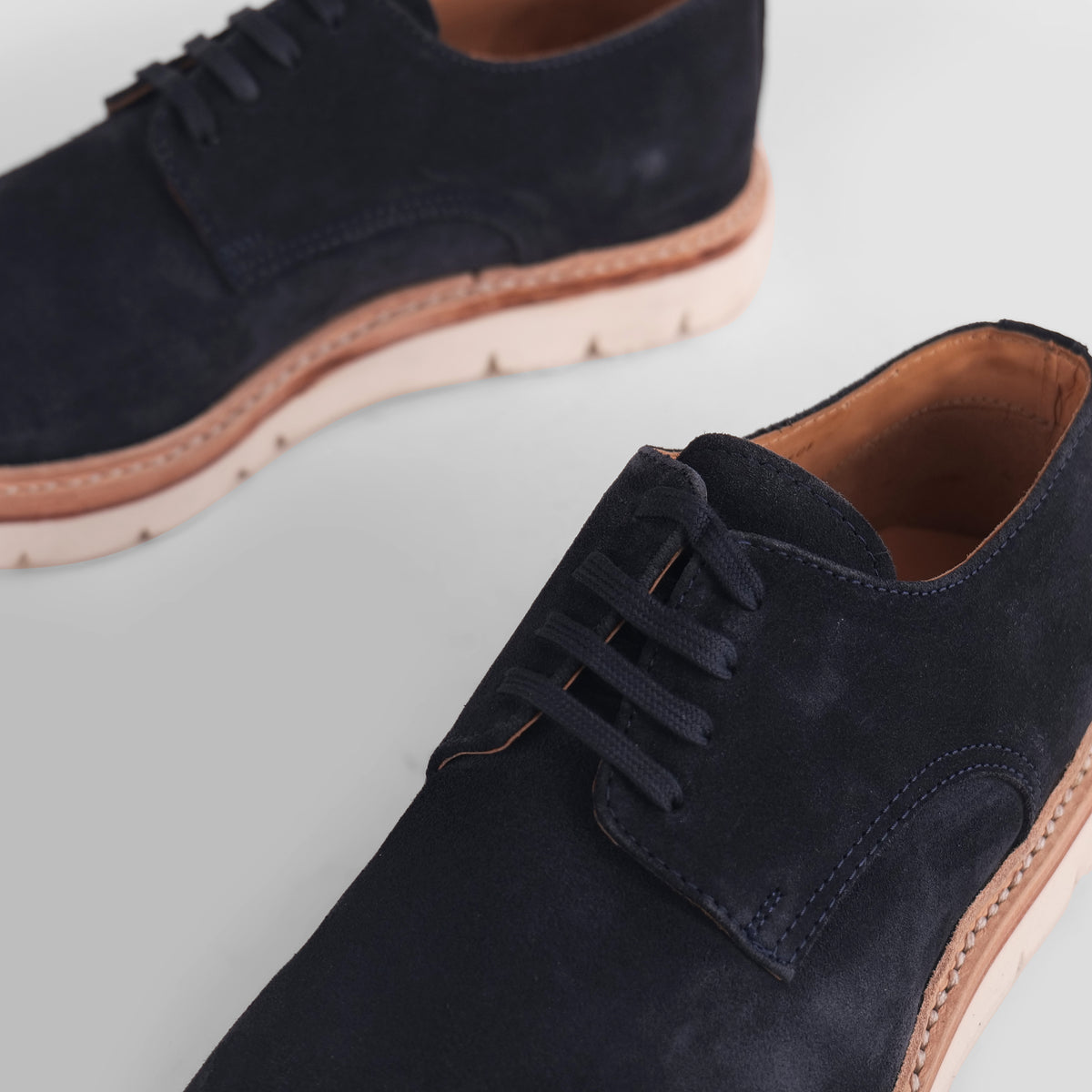 Close-up of navy blue Blucher Suede shoe highlighting lace detail